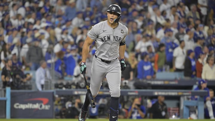 Oct 25, 2024; Los Angeles, California, USA; New York Yankees designated hitter Giancarlo Stanton (27) hits two-run home run in the sixth inning against the Los Angeles Dodgers during game one of the 2024 MLB World Series at Dodger Stadium. Mandatory Credit:  Jayne Kamin-Oncea-Imagn Images