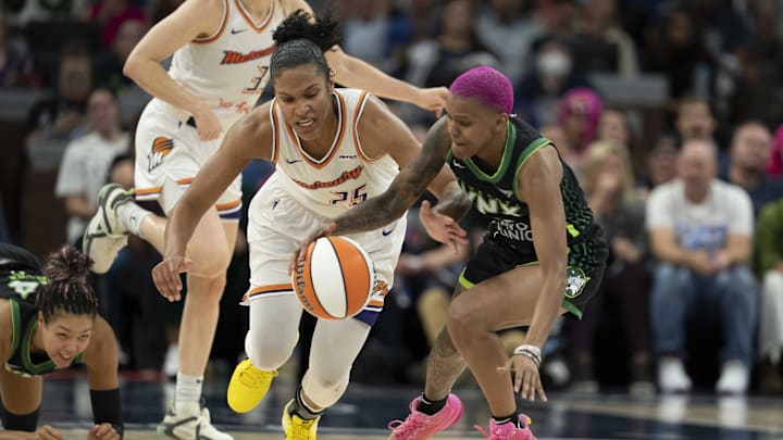 Sep 23, 2025; Minneapolis, Minnesota, USA; Minnesota Lynx guard Courtney Williams (10) dribbles as Phoenix Mercury forward Alyssa Thomas (25) attempts to steal the ball in the second half during game two of the second round for the 2025 WNBA Playoffs at Target Center. Mandatory Credit: Jesse Johnson-Imagn Images