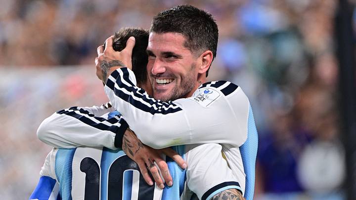 Rodrigo De Paul and Lionel Messi hug after combining to give Argentina the lead Tuesday against Algeria in a World Cup group stage match.