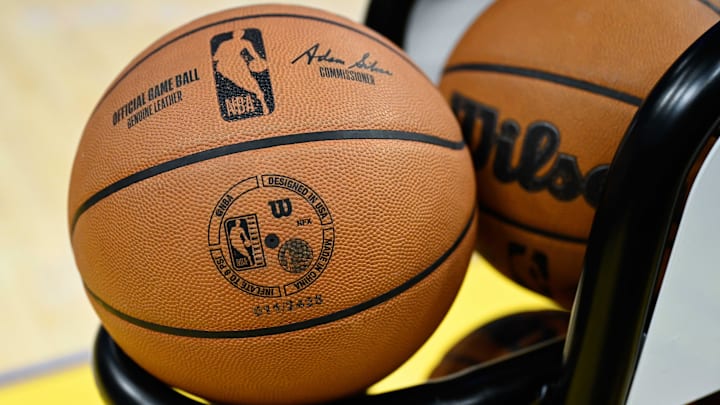 The NBA logo is seen on a basketball.