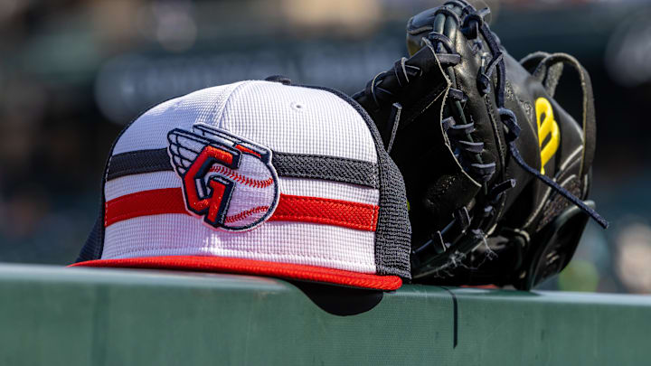 Jul 8, 2024; Detroit, Michigan, USA; A Cleveland Guardians baseball cap and glove sit on the dugout rail before the game against the Detroit Tigers at Comerica Park. Mandatory Credit: David Reginek-Imagn Images