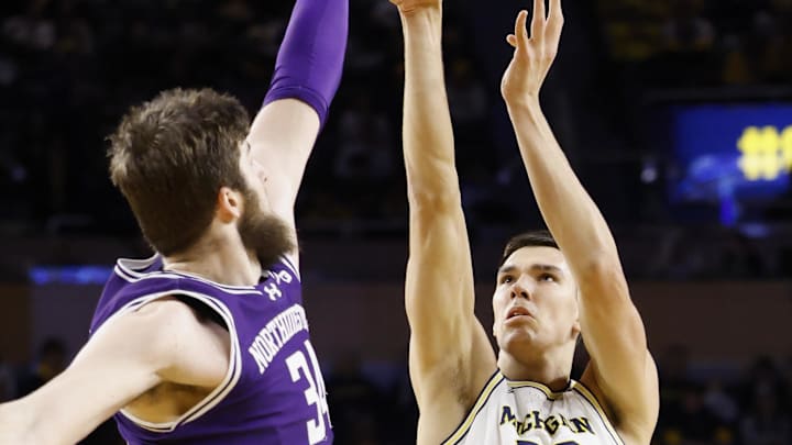 Jan 19, 2025; Ann Arbor, Michigan, USA; Michigan Wolverines center Vladislav Goldin (50) shoots over Northwestern Wildcats center Matthew Nicholson (34) in the first half at Crisler Center. Mandatory Credit: Rick Osentoski-Imagn Images