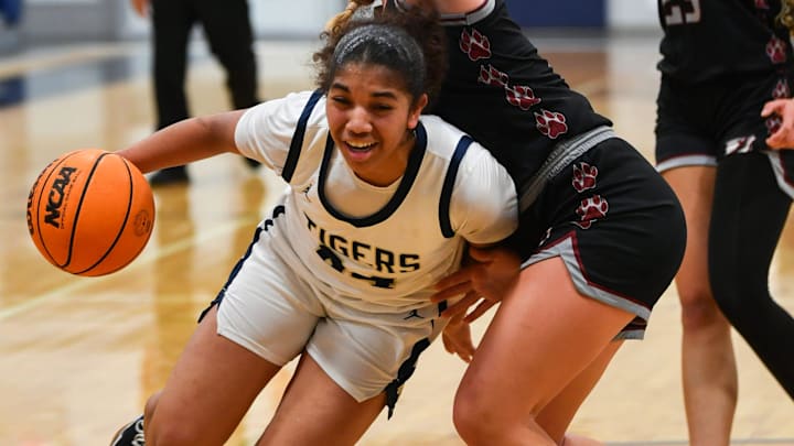 Leila Bryant of Holy Trinity drives past an Edgewood player on Jan. 27, 2025. Last week, she pumped in 21 points, including five 3-pointers, and added six rebounds and six steals to power the Tigers past Lakeland Christian, 67-13, for the Class 2A, Region 2 championship. Craig Bailey/FLORIDA TODAY via USA TODAY NETWORK