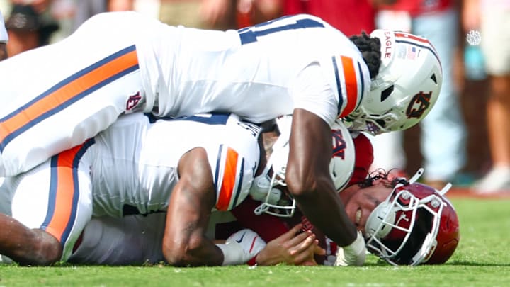 Sep 20, 2025; Norman, Oklahoma, USA;  Auburn Tigers defensive end Jared Smith (41) and Auburn Tigers linebacker Xavier Atkins (17) tackle Oklahoma Sooners quarterback John Mateer (10) during the first half at Gaylord Family-Oklahoma Memorial Stadium. Mandatory Credit: Kevin Jairaj-Imagn Images