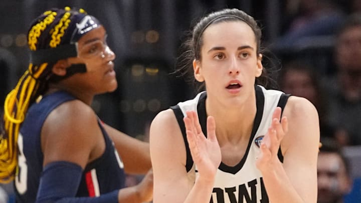 Iowa Hawkeyes guard Caitlin Clark (22) claps after a basket during the Final Four round of the NCAA