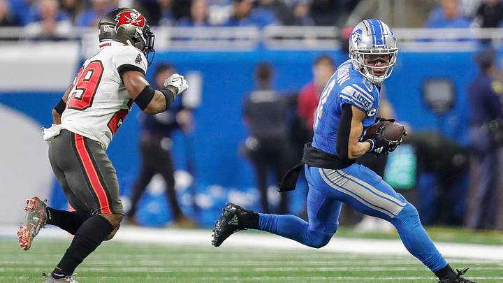 Detroit Lions wide receiver Amon-Ra St. Brown (14) makes a catch against Tampa Bay Buccaneers safety Christian Izien (29) during the first half of the NFC divisional round at Ford Field in Detroit on Sunday, Jan. 21, 2024.