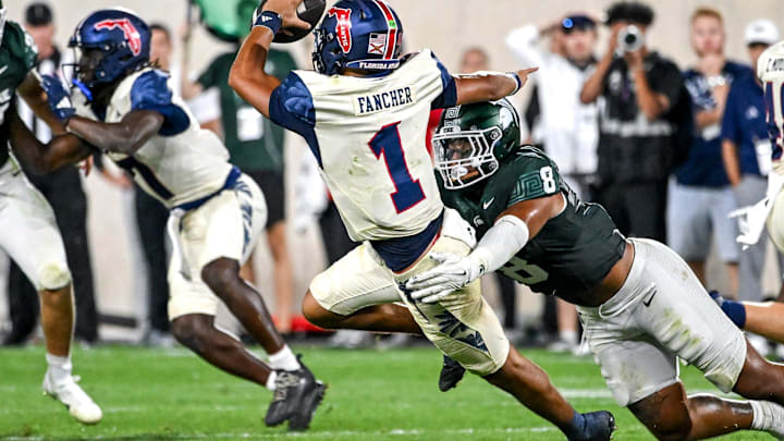 Michigan State's Anthony Jones, right, tackles Florida Atlantic's Cam Fancher during the fourth quarter on Friday, Aug. 30, 2024, at Spartan Stadium in East Lansing.