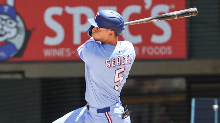 May 4, 2025; Arlington, Texas, USA;  Texas Rangers shortstop Corey Seager (5) hits a two-run single during the third inning against the Seattle Mariners at Globe Life Field. 