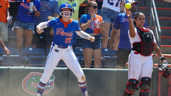 Florida outfielder Cassidy McLellan (22) celebrates stealing home past Texas Tech catcher Lagi Quiroga (4) during game 2 of the super regional of the NCAA Division 1 softball championship at Katie Seashole Pressly Stadium in Gainesville, FL on Saturday, May 23, 2026. [Alan Youngblood/Gainesville Sun]