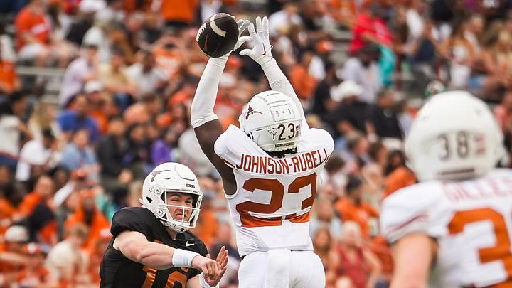 Texas defensive back Jordon Johnson-Rubell misses intercepting a pass from Texas quarterback Cole Lourd Texas defensive back Jordon Johnson-Rubell misses intercepting a pass from Texas quarterback Cole Lourd