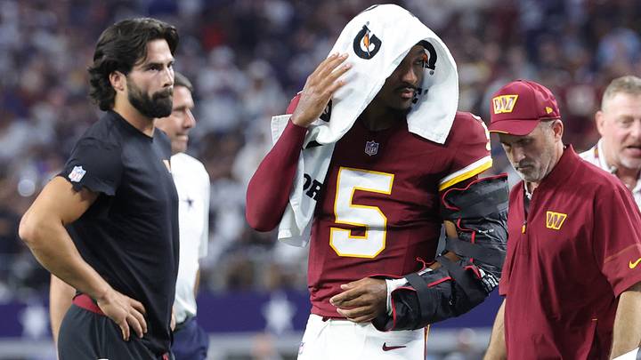 Sep 20, 2026; Arlington, Texas, USA; Washington Commanders quarterback Jayden Daniels (5) leaves the game with an apparent injury to his left arm during the second half against the Dallas Cowboys at AT&T Stadium. Mandatory Credit: Kevin Jairaj-Imagn Images Sep 20, 2026; Arlington, Texas, USA; Washington Commanders quarterback Jayden Daniels (5) leaves the game with an apparent injury to his left arm during the second half against the Dallas Cowboys at AT&T Stadium. Mandatory Credit: Kevin Jairaj-Imagn Images