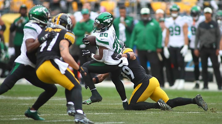 Breece Hall (20) of the New York Jets gets wrapped up by Minkah Fitzpatrick (39) of the Pittsburgh Steelers during the first half at Acrisure Stadium in Pittsburgh, PA on October 2, 2022.

Pittsburgh Steelers Vs New York Jets Week 4