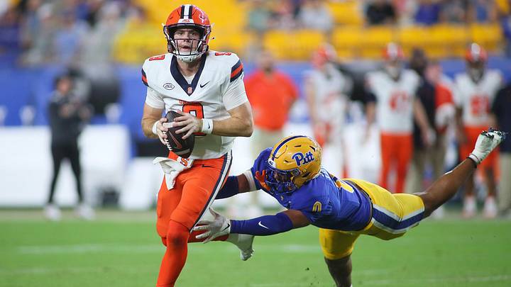 Syracuse Orange quarterback Steve Angeli (9) looks downfield for an open receiver while being pressured by Pittsburgh Panthers linebacker Braylan Lovelace (0) during the first half at Acrisure Stadium in Pittsburgh, PA on September 17, 2026. Syracuse Orange quarterback Steve Angeli (9) looks downfield for an open receiver while being pressured by Pittsburgh Panthers linebacker Braylan Lovelace (0) during the first half at Acrisure Stadium in Pittsburgh, PA on September 17, 2026.