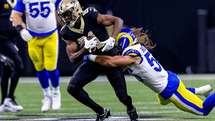 Dec 1, 2024; New Orleans, Louisiana, USA;  New Orleans Saints wide receiver Kevin Austin Jr. (81) is tackled by Los Angeles Rams linebacker Christian Rozeboom (56) during the first half at Caesars Superdome. Mandatory Credit: Stephen Lew-Imagn Images