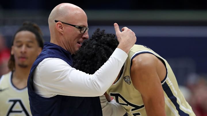 Akron Zips head coach John Groce has a moment with forward Enrique Freeman during the second half of