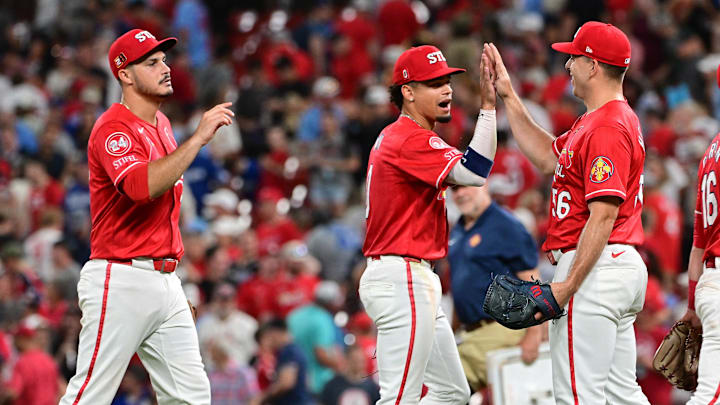 Aug 17, 2024; St. Louis, Missouri, USA;  St. Louis Cardinals third base Nolan Arenado (28) and shortstop Masyn Winn (0) greet St. Louis Cardinals pitcher Ryan Helsley (56, right) after Helsley pitched in relief in the ninth inning against the Los Angeles Dodgers at Busch Stadium. Mandatory Credit: Tim Vizer-Imagn Images