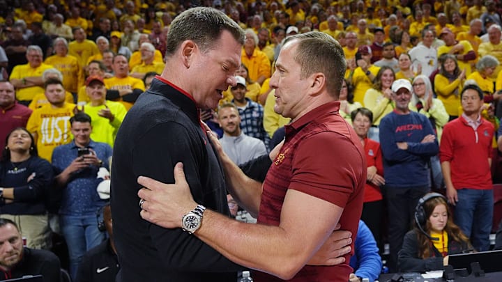 Iowa State Cyclones men's basketball head coach T.J. Otzelberger greets Arizona Wildcats men's basketball head coach Tommy Lloyd before their Big 12 men’s basketball showdown at Hilton Coliseum on Saturday, March 1, 2025 in Ames, Iowa.