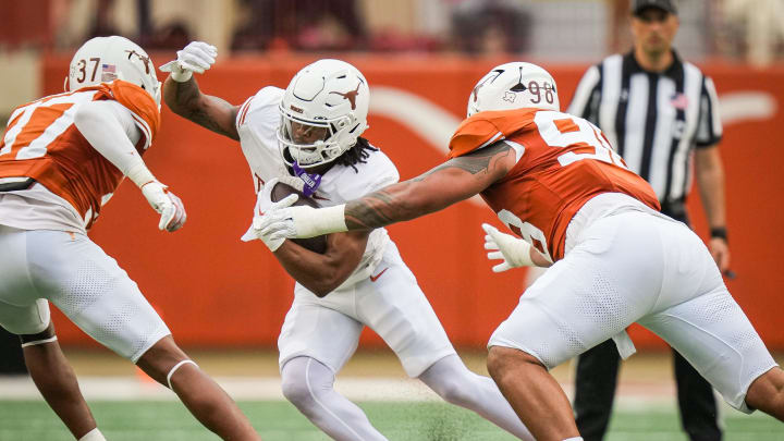 April 20, 2024; Austin, Texas, USA: Texas White team running back Jaydon Blue (23) navigates between defense from Texas Orange linebacker Morice Blackwell Jr. (37) and defensive lineman Tiaoalii Savea (98) in the second quarter of the Longhorns' spring Orange and White game at Darrell K Royal Texas Memorial Stadium. Mandatory Credit: Sara Diggins-USA Today Sports via American Statesman April 20, 2024; Austin, Texas, USA: Texas White team running back Jaydon Blue (23) navigates between defense from Texas Orange linebacker Morice Blackwell Jr. (37) and defensive lineman Tiaoalii Savea (98) in the second quarter of the Longhorns' spring Orange and White game at Darrell K Royal Texas Memorial Stadium. Mandatory Credit: Sara Diggins-USA Today Sports via American Statesman