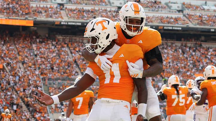 Sep 5, 2026; Knoxville, Tennessee, USA;  Tennessee Volunteers quarterback Faizon Brandon (11) and running back DeSean Bishop (18) celebrate a touchdown against the Furman Paladins during the first half at Neyland Stadium.  Mandatory Credit: Randy Sartin-Imagn Images