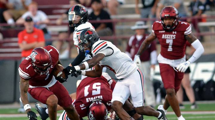 Aggie Seth McGowan crashes into the defensive secondary as NMSU took on SEMO Saturday night, August 31, 2024.