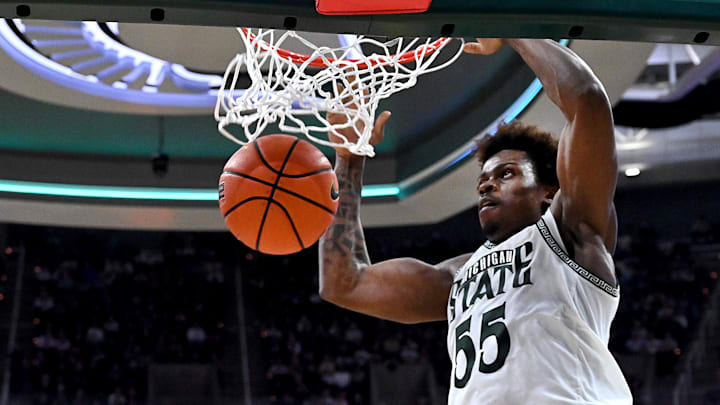 Feb 17, 2026; East Lansing, Michigan, USA; Michigan State Spartans forward Coen Carr (55) gets a slam dunk against the UCLA Bruins during the second half at Jack Breslin Student Events Center. Mandatory Credit: Dale Young-Imagn Images