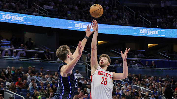 Mar 19, 2025; Orlando, Florida, USA; Houston Rockets center Alperen Sengun (28) shoots against Orlando Magic forward Franz Wagner (22) during the second half at Kia Center. Mandatory Credit: Mike Watters-Imagn Images