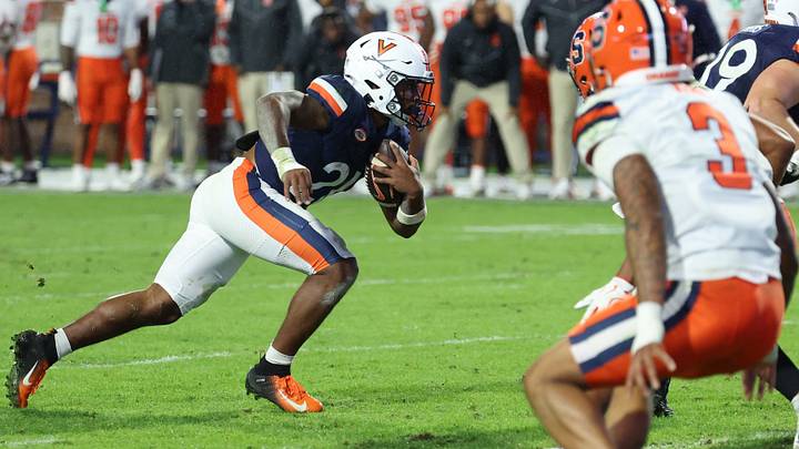 Oct 10, 2026; Charlottesville, Virginia, USA; Virginia Cavaliers running back Xay Davis (25) carries the ball past Syracuse Orange defensive back Davien Kerr (3) en route to a touchdown in the fourth quarter at Scott Stadium. Mandatory Credit: Geoff Burke-Imagn Images