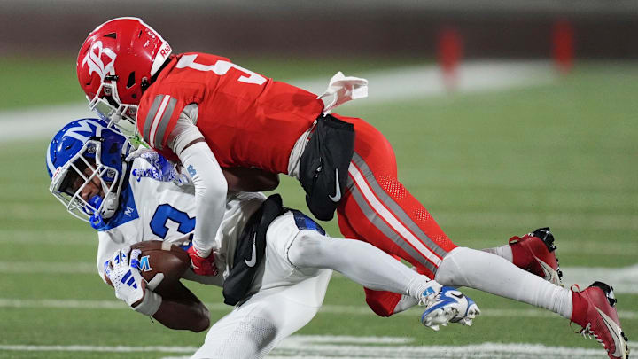 McCallie's Loia Valade (13) is tackled by Baylor's Jamyan Theodore (5) during the TSSAA Division II-AAA high school football Bluecross Bowl on Thursday, Dec. 5, 2024, in Chattanooga, Tenn.