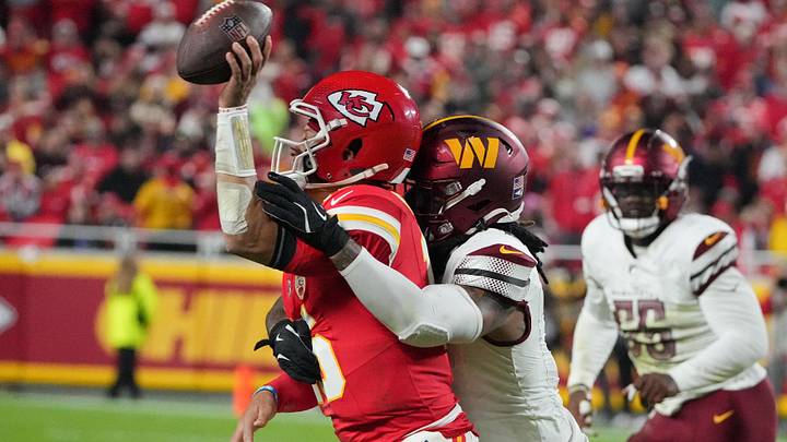 Oct 27, 2025; Kansas City, Missouri, USA; Kansas City Chiefs quarterback Patrick Mahomes (15) passes the ball defended by Washington Commanders linebacker Frankie Luvu (4) during the second quarter of the game at GEHA Field at Arrowhead Stadium. Mandatory Credit: Denny Medley-Imagn Images