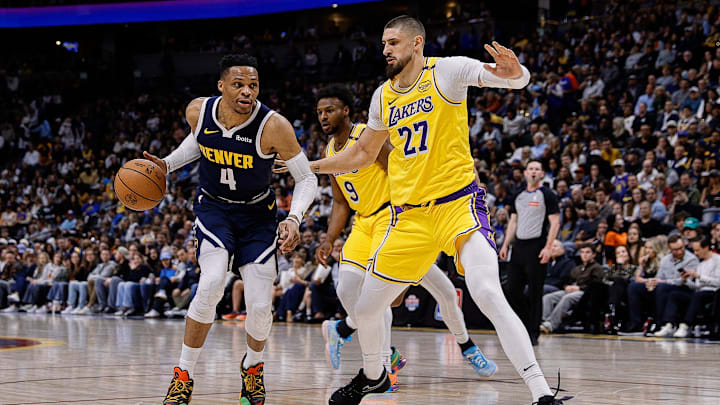 Mar 14, 2025; Denver, Colorado, USA; Denver Nuggets guard Russell Westbrook (4) controls the ball as Los Angeles Lakers center Alex Len (27) guards in the second quarter at Ball Arena. Mandatory Credit: Isaiah J. Downing-Imagn Images
