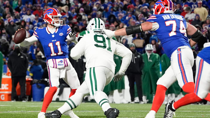 Jan 4, 2026; Orchard Park, New York, USA; Buffalo Bills quarterback Mitchell Trubisky (11) passes the ball under pressure from New York Jets defensive tackle Jowon Briggs (91) during the third quarter at Highmark Stadium. Mandatory Credit: Gregory Fisher-Imagn Images