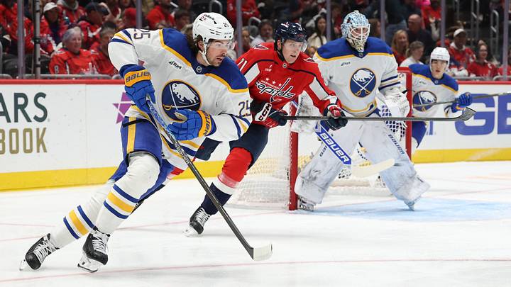 Buffalo Sabres defenseman Owen Power (25) skates with the puck as Washington Capitals left wing Aliaksei Protas (21) chases during the first period at Capital One Arena. Mandatory Credit: Geoff Burke-Imagn Images