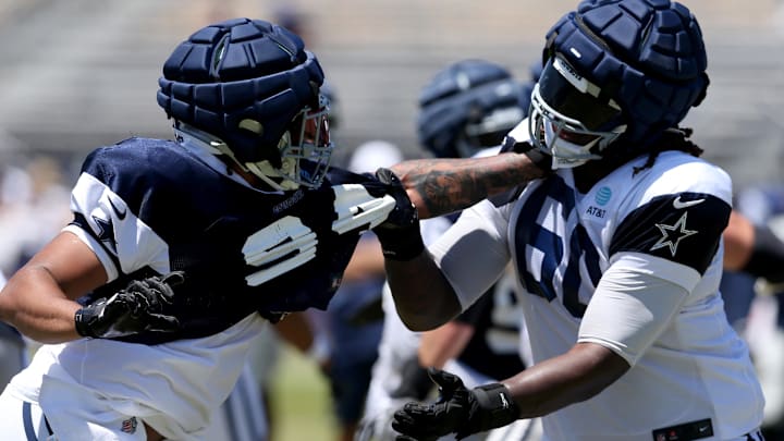 Dallas Cowboys defensive end Marshawn Kneeland and offensive tackle Tyler Guyton battle during training camp.