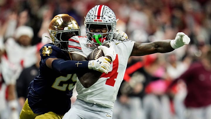 Ohio State Buckeyes wide receiver Jeremiah Smith (4) makes a catch against Notre Dame Fighting Irish cornerback Christian Gray (29) in the fourth quarter during the College Football Playoff National Championship at Mercedes-Benz Stadium in Atlanta on January 20, 2025.