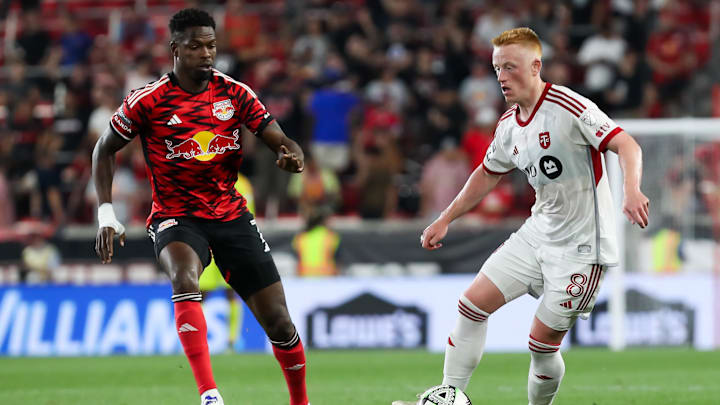 Toronto FC midfielder Matty Longstaff (8) moves the ball against New York Red Bulls forward Cory Burke (7)  