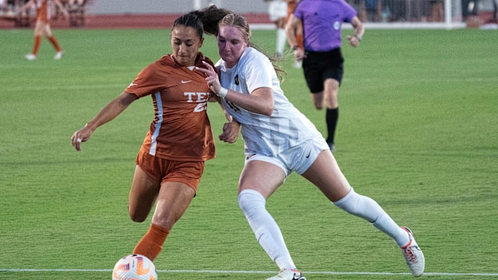 Sep 28, 2023; Austin, Texas, USA; West Virginia Mountaineers forward Jordyn Wilson (11) and Texas Longhorns defender Lauren Lapomarda (25) battle for the ball during the match at Mike A. Myers Stadium and Soccer Field in Austin, Texas. Mandatory Credit: Scott Wachter-Imagn Images