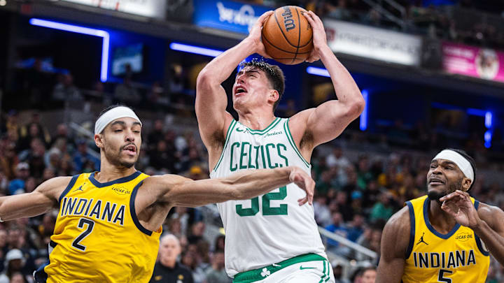 Dec 26, 2025; Indianapolis, Indiana, USA; Boston Celtics center Luka Garza (52) shoots the ball while Indiana Pacers guard/forward Andrew Nembhard (2)  defends in the second half at Gainbridge Fieldhouse. Mandatory Credit: Trevor Ruszkowski-Imagn Images