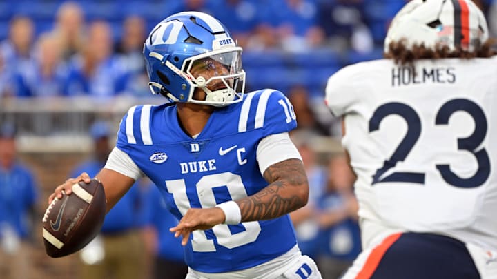 Nov 15, 2025; Durham, North Carolina, USA;  Duke Blue Devils quarter back Darian Mensah (10) drops back for a pass against Virginia Cavaliers defensive lineman Jacob Holmes (23) during the first quarter at Wallace Wade Stadium. Mandatory Credit: Zachary Taft-Imagn Images