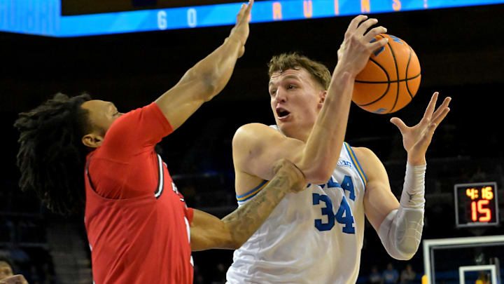 Feb 3, 2026; Los Angeles, California, USA;  UCLA Bruins forward Tyler Bilodeau (34) is defended by Rutgers Scarlet Knights guard Lino Mark (2) in the first half at Pauley Pavilion presented by Wescom Financial. Mandatory Credit: Jayne Kamin-Oncea-Imagn Images