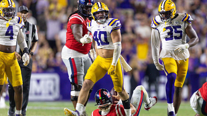 Oct 12, 2024; Baton Rouge, Louisiana, USA; LSU Tigers linebacker Whit Weeks (40) reacts after sacking Mississippi Rebels quarterback Jaxson Dart (2) during the second half at Tiger Stadium. Mandatory Credit: Stephen Lew-Imagn Images Oct 12, 2024; Baton Rouge, Louisiana, USA; LSU Tigers linebacker Whit Weeks (40) reacts after sacking Mississippi Rebels quarterback Jaxson Dart (2) during the second half at Tiger Stadium. Mandatory Credit: Stephen Lew-Imagn Images