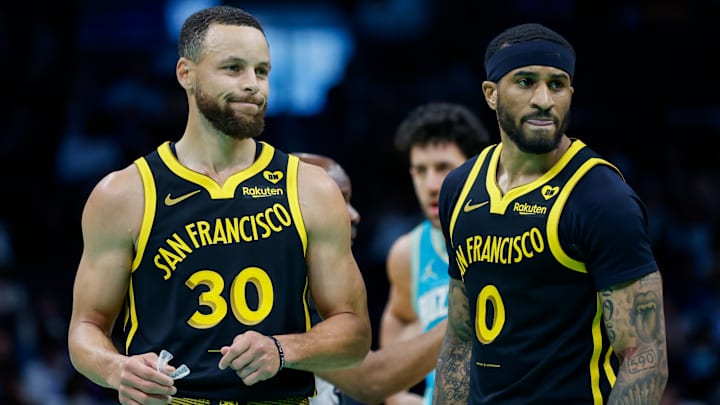 Golden State Warriors guards Stephen Curry (30) and Gary Payton II look to the bench during a break in the action against the Charlotte Hornets during the first quarter at Spectrum Center in Charlotte, N.C., on March 29, 2024. Golden State Warriors guards Stephen Curry (30) and Gary Payton II look to the bench during a break in the action against the Charlotte Hornets during the first quarter at Spectrum Center in Charlotte, N.C., on March 29, 2024.