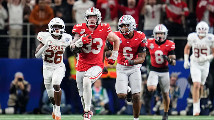 Ohio State Buckeyes defensive end Jack Sawyer (33) returns a fumble recovery for a touchdown after sacking Texas Longhorns quarterback Quinn Ewers (3) during the second half of the Cotton Bowl Classic College Football Playoff semifinal game 