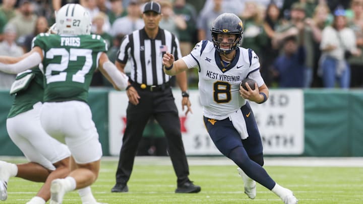 Sep 6, 2025; Athens, Ohio, USA; West Virginia Mountaineers quarterback Nicco Marchiol (8) runs the ball during the first quarter against the Ohio Bobcats at Peden Stadium. Mandatory Credit: Ben Queen-Imagn Images