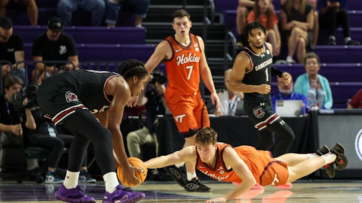 Nov 27, 2024; Fort Myers, Florida, USA; South Carolina Gamecocks forward Collin Murray-Boyles (30) and Virginia Tech Hokies guard Jaden Schutt (2) scramble for a loose ball in the first half at Suncoast Credit Union Arena. Mandatory Credit: Nathan Ray Seebeck-Imagn Images