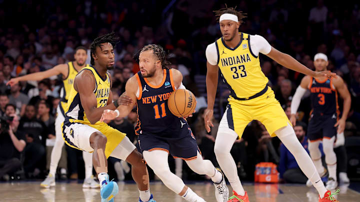 Feb 1, 2024; New York, New York, USA; New York Knicks guard Jalen Brunson (11) controls the ball against Indiana Pacers forward Aaron Nesmith (23) and center Myles Turner (33) during the first quarter at Madison Square Garden. Mandatory Credit: Brad Penner-Imagn Images