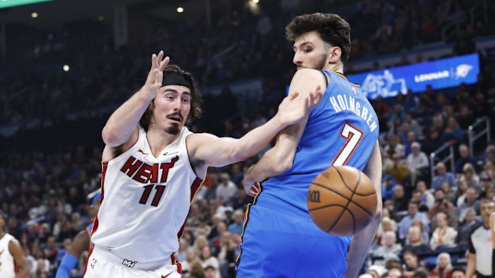 Mar 8, 2024; Oklahoma City, Oklahoma, USA; Miami Heat guard Jaime Jaquez Jr. (11) reaches for a rebound behind Oklahoma City Thunder forward Chet Holmgren (7) during the second quarter at Paycom Center. Mandatory Credit: Alonzo Adams-Imagn Images