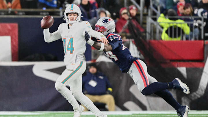Miami Dolphins quarterback Quinn Ewers (14) scrambles against New England Patriots linebacker K'Lavon Chaisson (44) during the fourth quarter at Gillette Stadium. Miami Dolphins quarterback Quinn Ewers (14) scrambles against New England Patriots linebacker K'Lavon Chaisson (44) during the fourth quarter at Gillette Stadium.