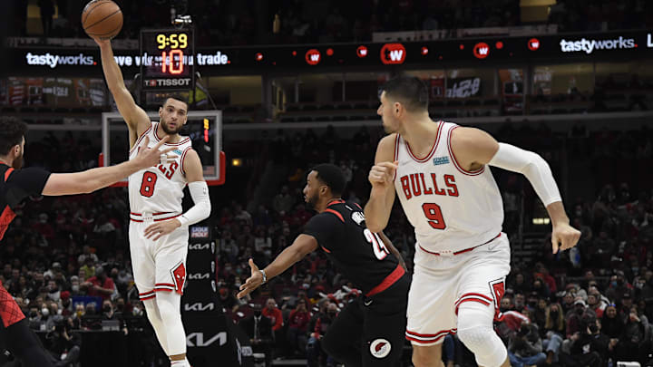 Jan 30, 2022; Chicago, Illinois, USA;  Chicago Bulls guard Zach LaVine (8) passes to Chicago Bulls center Nikola Vucevic (9) as Portland Trail Blazers forward Norman Powell (24) looks on during the first half at the United Center. Mandatory Credit: Matt Marton-Imagn Images