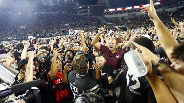 Sep 6, 2025; Starkville, Mississippi, USA; Mississippi State Bulldogs fans crowd around quarterback Blake Shapen (2) after defeating the Arizona State Sun Devilsat Davis Wade Stadium at Scott Field. Mandatory Credit: Petre Thomas-Imagn Images