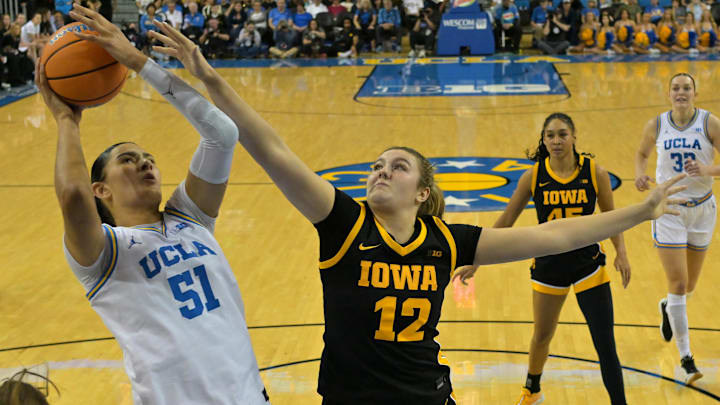 Feb 1, 2026; Los Angeles, California, USA;  UCLA Bruins center Lauren Betts (51) is defended by Iowa Hawkeyes center Layla Hays (12) as she shoots a basket in the first half at Pauley Pavilion presented by Wescom Financial. Mandatory Credit: Jayne Kamin-Oncea-Imagn Images